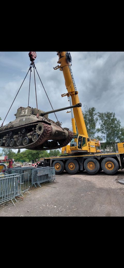 Char suspendu devant une grue Cantiniau lors de son installation à Hautmont